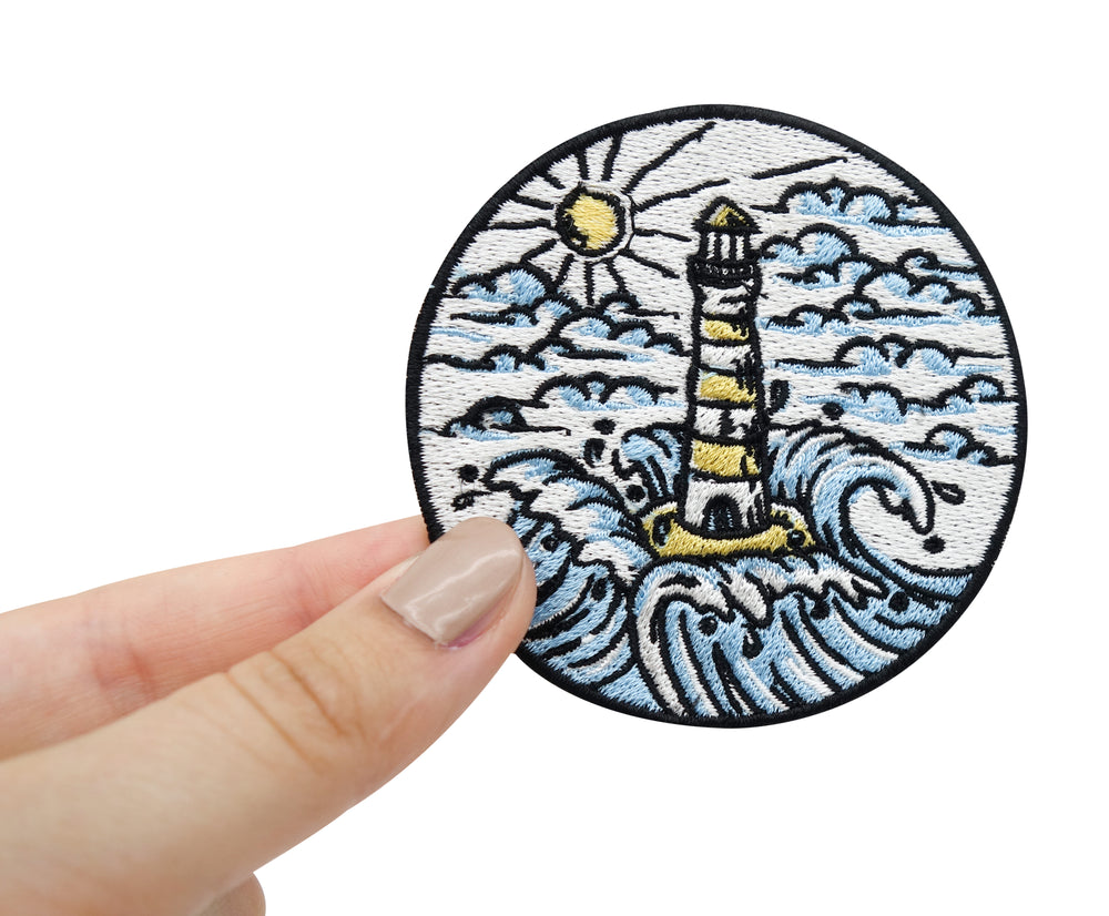 Hand einer Frau hält den Leuchtturm-Patch