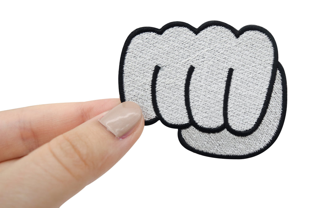 Cartoon Faust Patch gehalten von einer Frauenhand