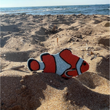 Clown Fisch Patch im Sand mit dem Meer im Hintergund