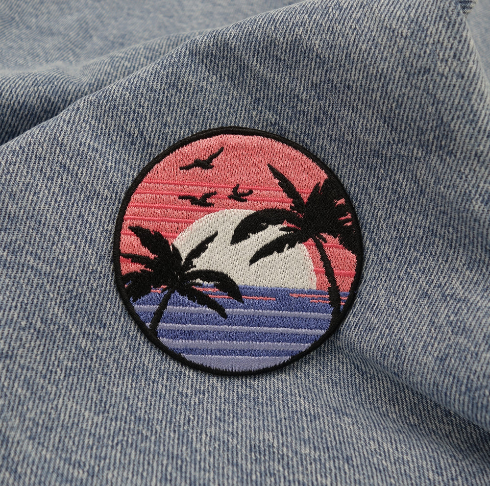 Sonnenuntergang Patch auf blauer Jeans aufgebügelt