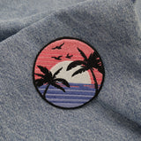 Sonnenuntergang Patch auf blauer Jeans aufgebügelt