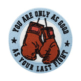 Hellblauer mit roten Boxhandschuhen Patch und dem Spruch: You are as good as your last fight
