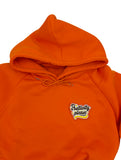 Positivity Patch auf orangenem Pullover aufgebügelt