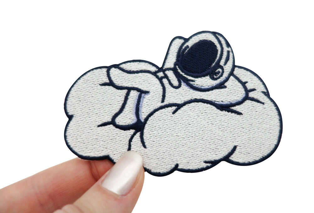 Astronaut auf Wolke Patch gehalten von einer Frauenhand