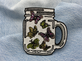 Schmetterlinge im Glas Patch auf blauer Jeans