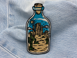 Wüste in der Flasche Patch auf blauer Jeans