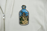 Wüste in der Flasche Patch auf weißer Strickjacke aufgebügelt