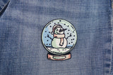 Schneemann Patch auf dunkelblauer Jeans