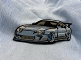 Sportwagen Patch auf hellblauer Jeans