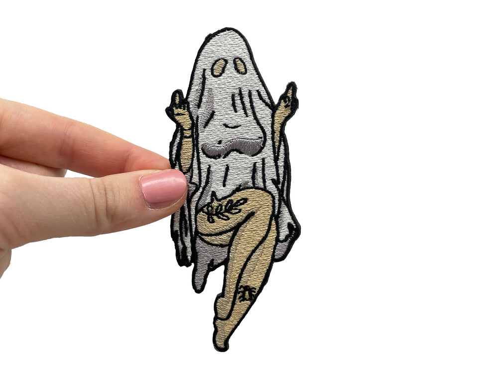 Frauenhand hält den Sexy Geist Patch
