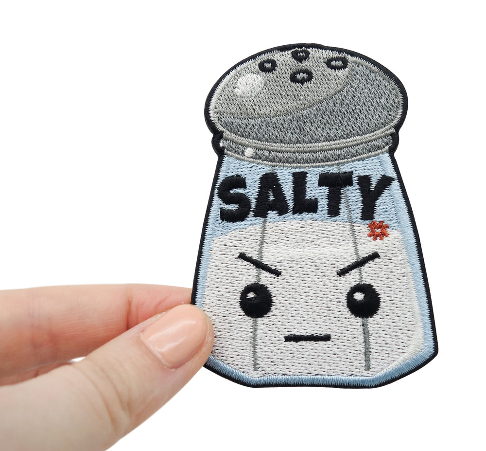 Frauenhand hält den Salty Salzstreuer Patch