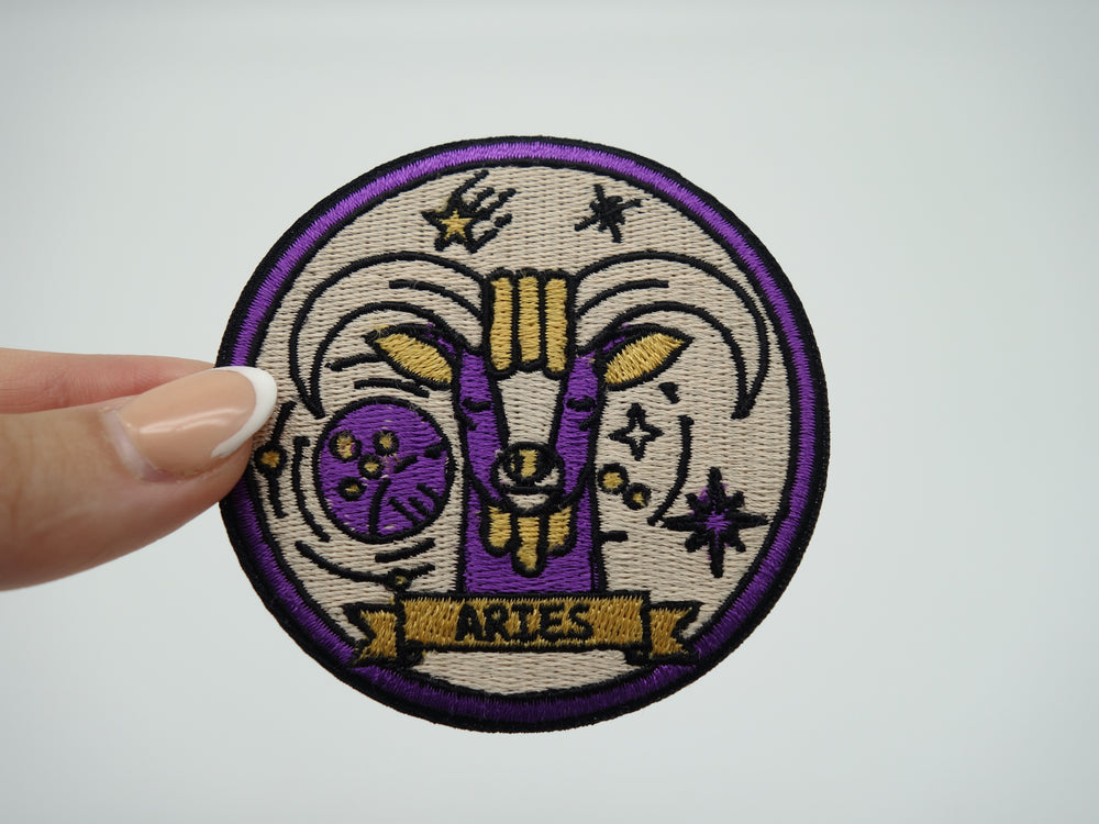 Frauenhand hält den Widder Sternzeichen Patch