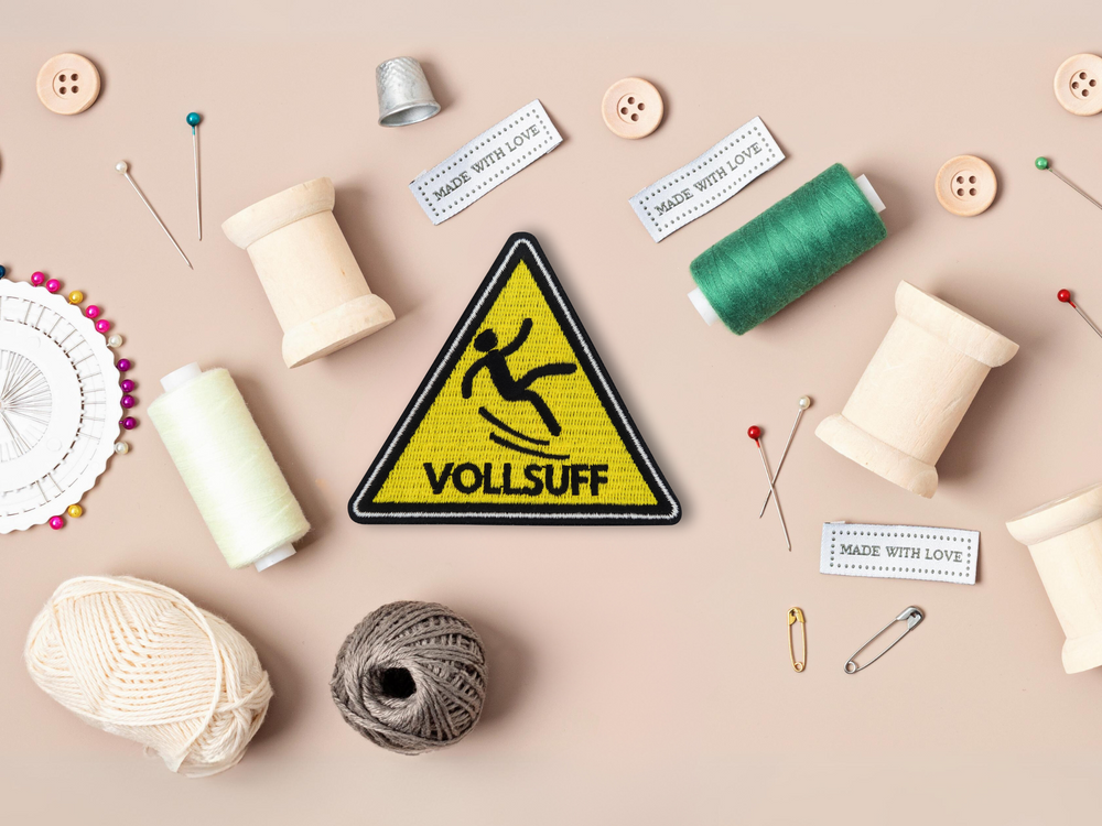 Gelber Warndreieck Vollsuff Patch mit Nähzeug im Hintergrund