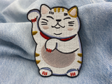 Glückskatzen Patch auf blauer Jeans