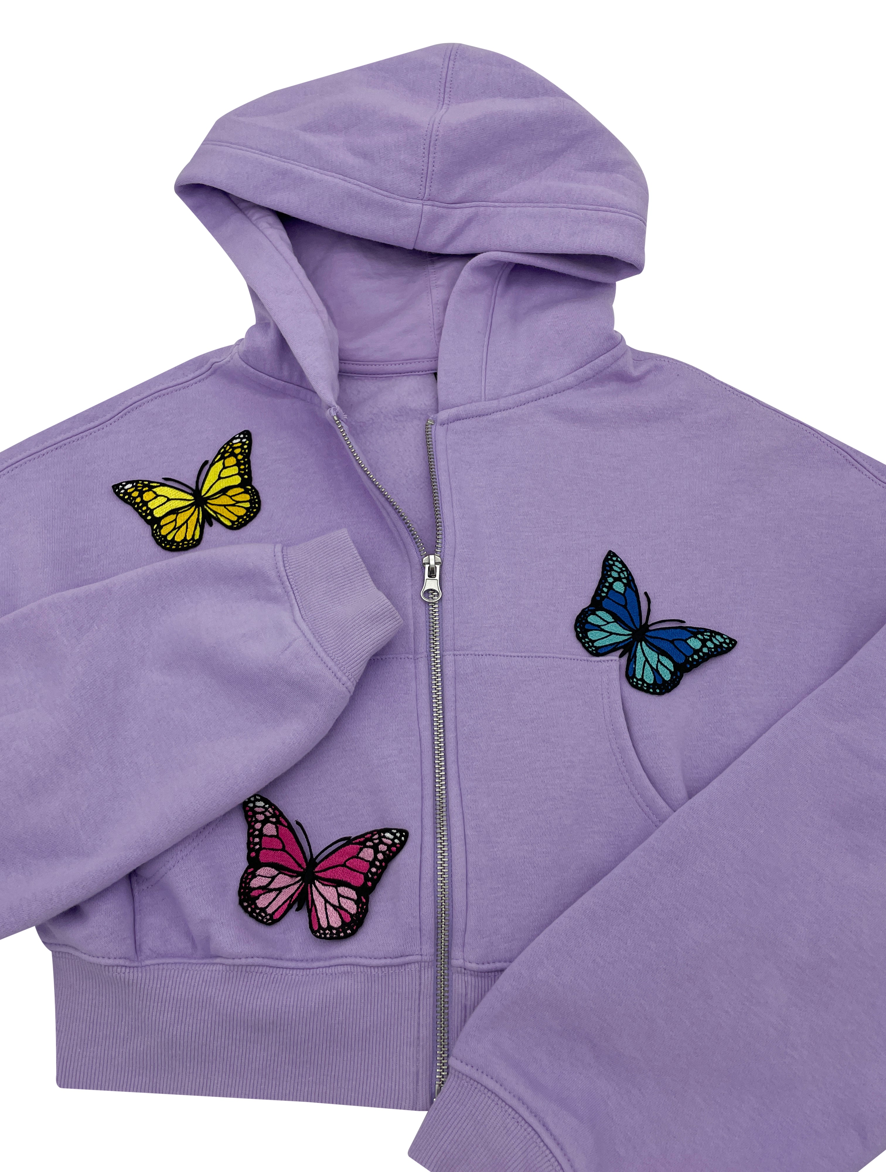 Verschieden farbige Schmetterling Patches auf violetter Jacke 