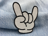 Cartoon Rocker Hand Patch auf blauer Jeans
