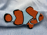 Clown Fisch Patch auf blauer Jeans