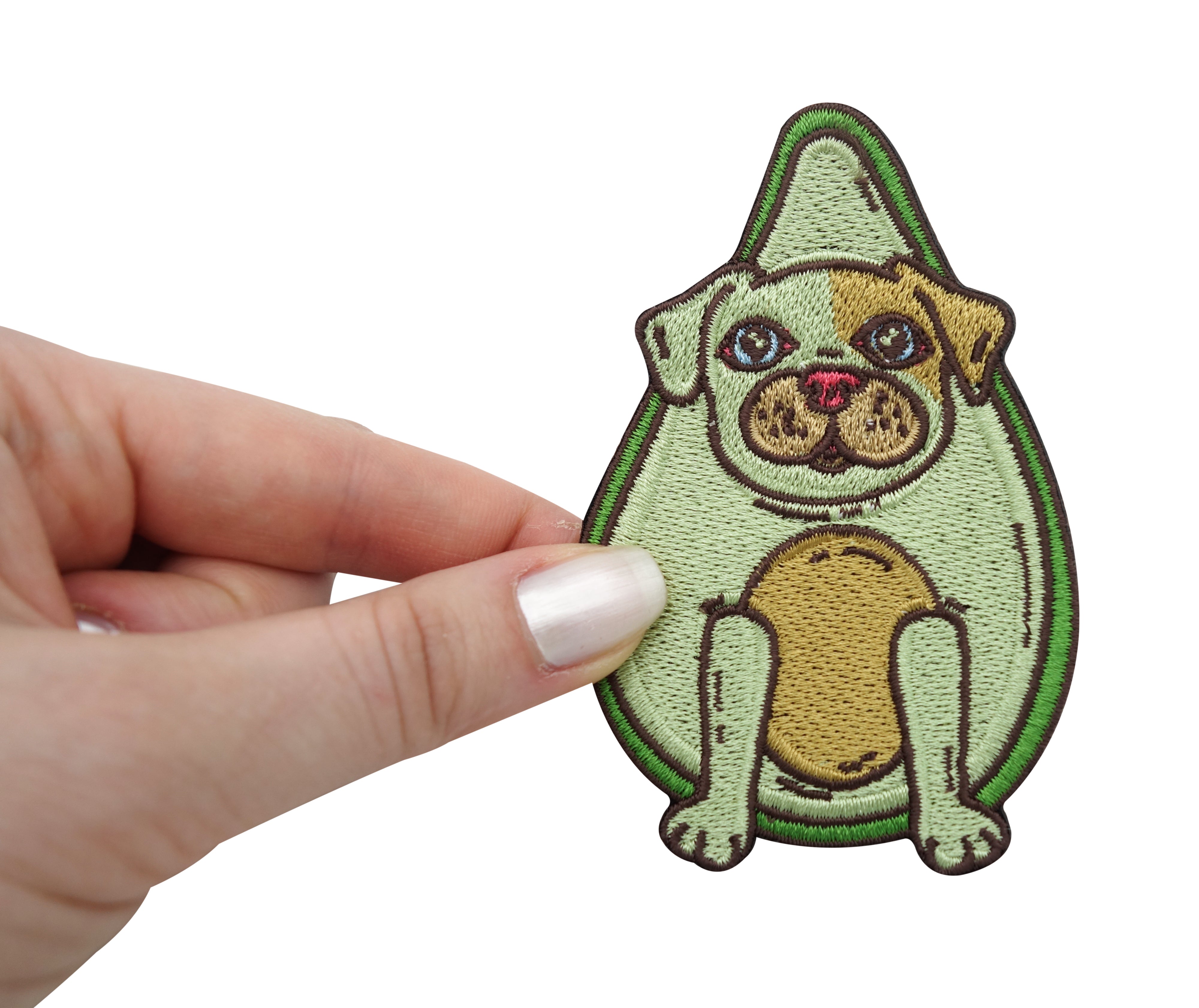 Frauenhand hält den Avocado Hund Patch 