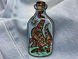 Krake in der Flsche Patch auf blauer Jeans