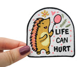 Frauenhand hält den Igel Patch 