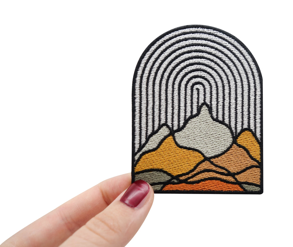 Frauenhand hält den Berge Patch
