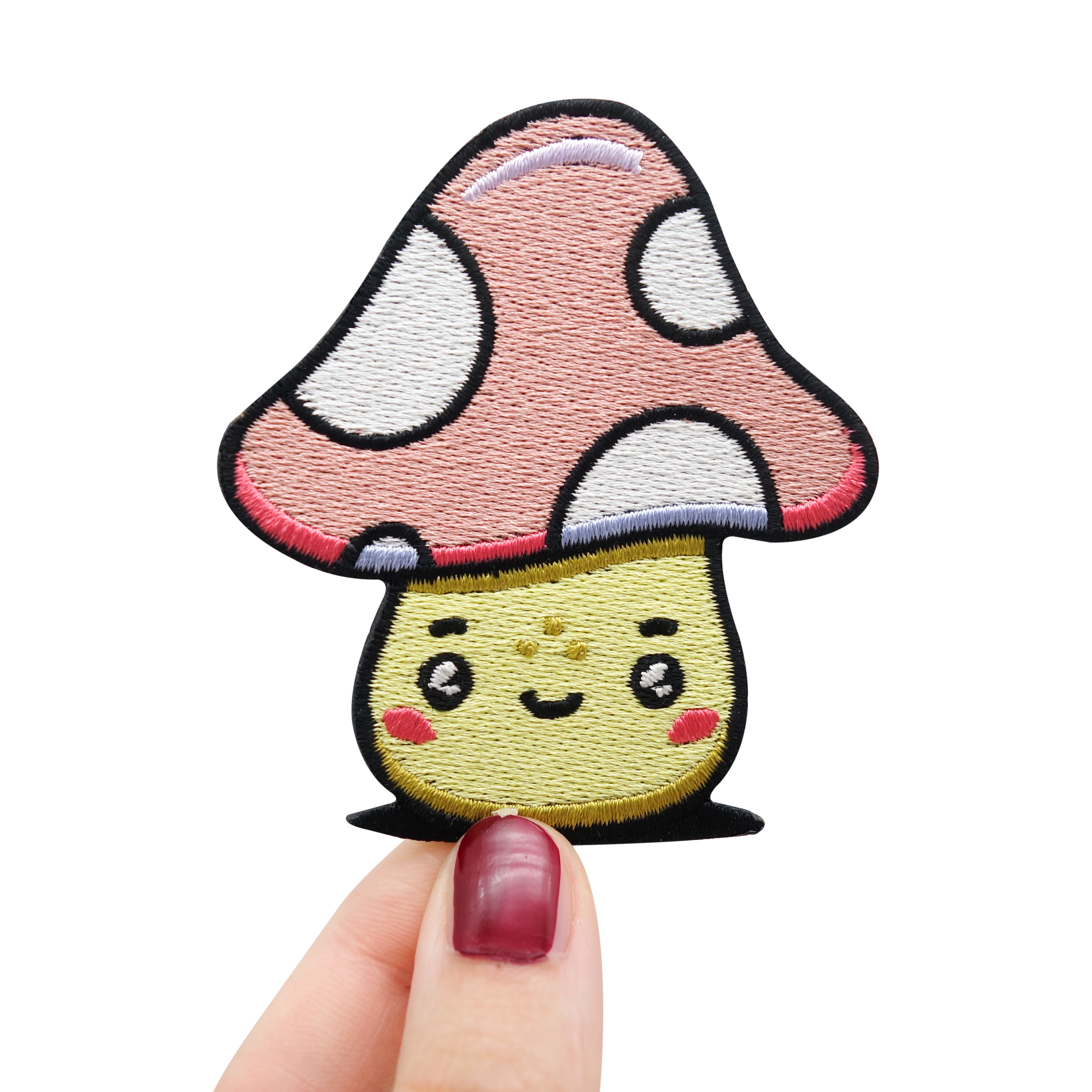 Frauenhand hält den Pilz Patch