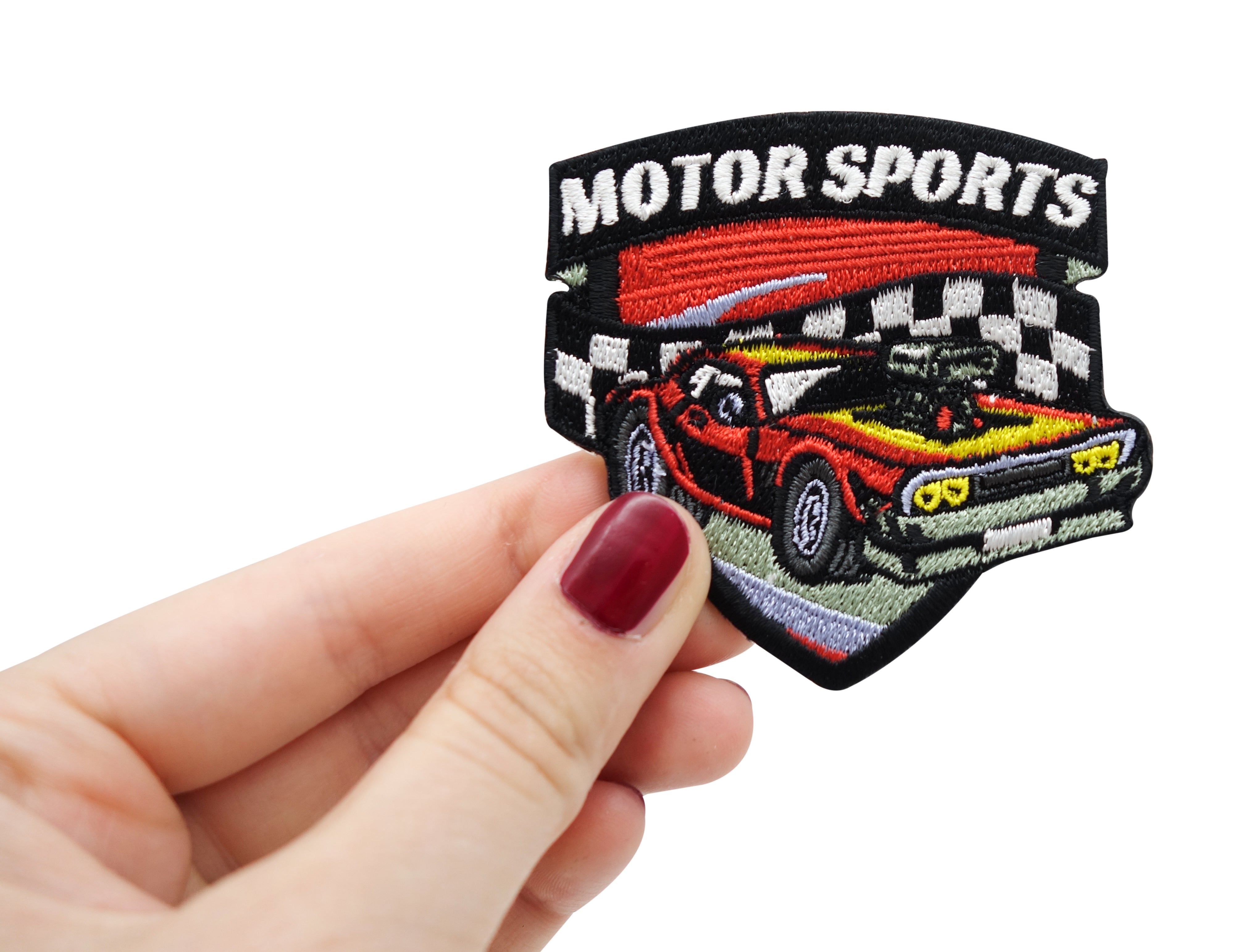 Frauenhand hält den Motorsport Patch