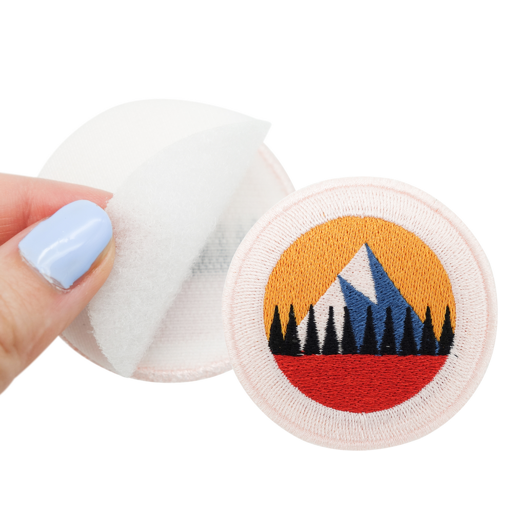Klettpatch mit Rückseite und extra Klettfläche gehalten von einer Frauenhand