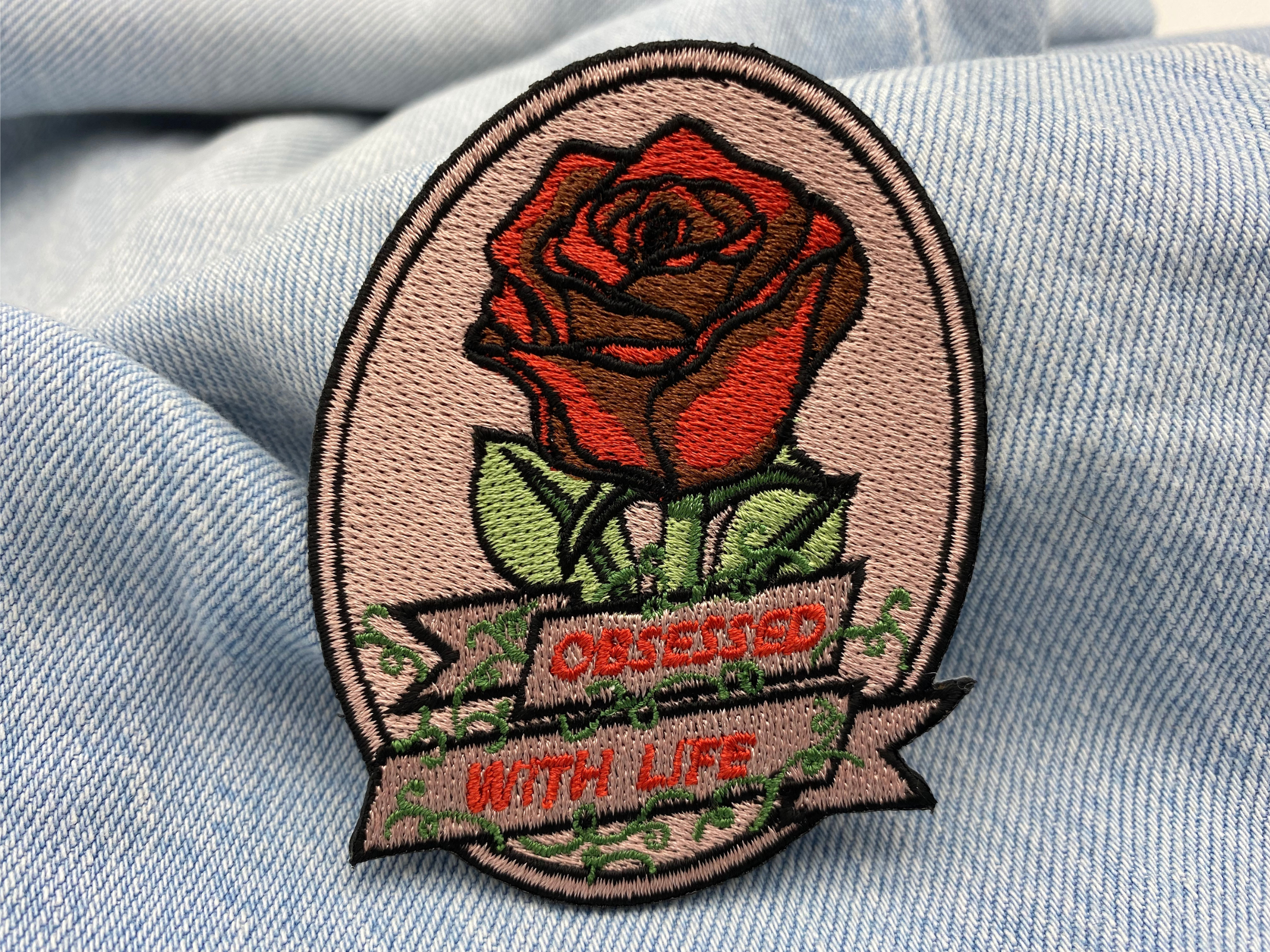 Rote Rose Patch auf hellblauer Jeans
