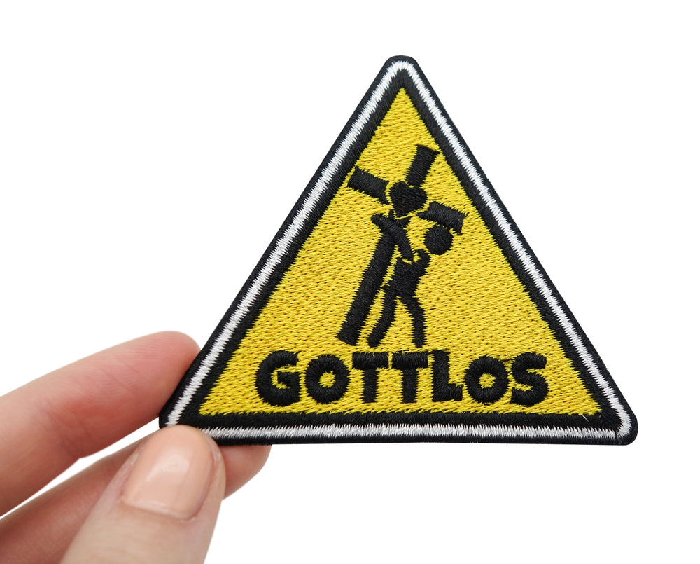 Frauenhand hält den Gottlos Patch