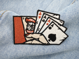 4 Asse Patch auf hellblauer Jeans