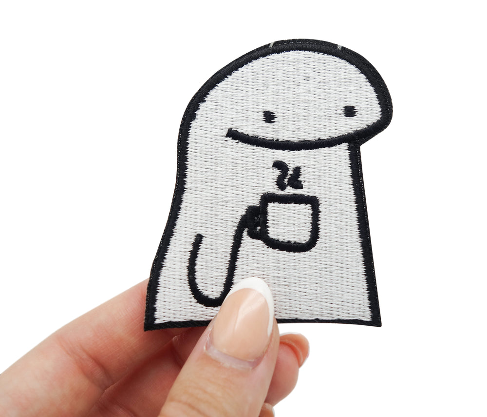 Frauenhand hält den Coffee Guy Patch
