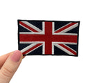 Frauenhand hält den Großbritannien Flagge Patch